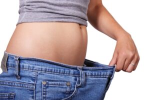 Skinny woman and evidence of weight loss via her big jeans. Pixaby