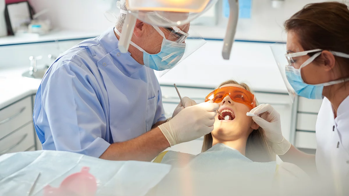 Dentist working in the mouth of a patient