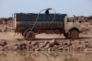 A man pumps water into a tanker in northeastern Jordan. (Image credit: Getty Images)