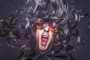 Musician looking a little crazy with big hair and sunglasses