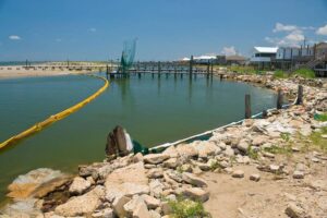 Small harbor with spilled oil in water