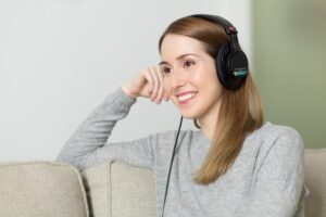 Woman listening to music on over the ear headphones
