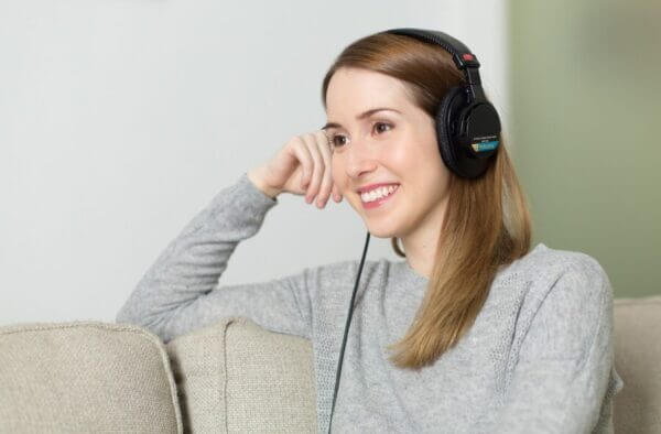 Woman listening to music on over the ear headphones