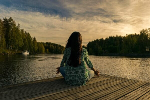 Woman on a dock, facing a body of water, sitting in ...                    </div>

                    <div class=