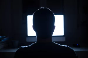 Young man watching tv in the dark