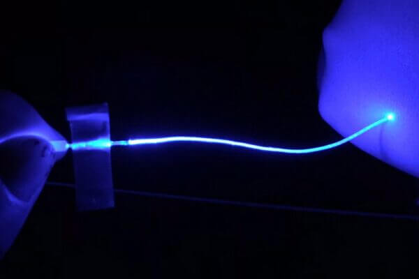 Soft optical fibers block pain while moving and stretching with the body