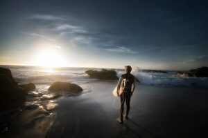 Man about to enter waves with surfboard