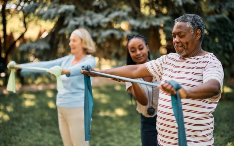 Black senior man exercising with others