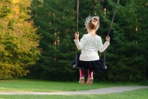 Young girl on a swing set