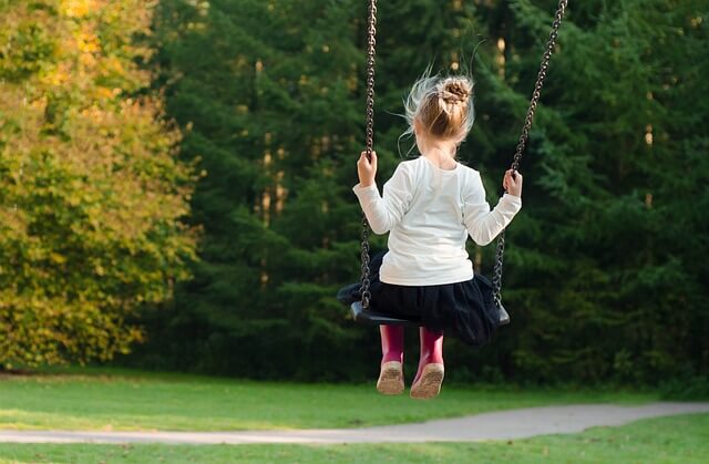 Young girl on a swing set