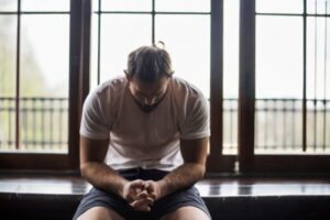 depressed man at gym with head bent down
