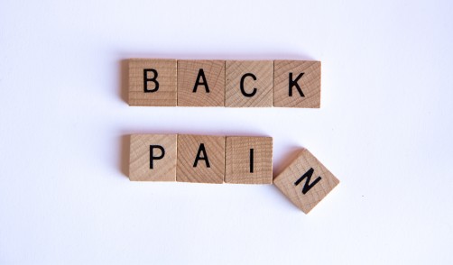 BACK PAIN spelled out in Scrabble tiles