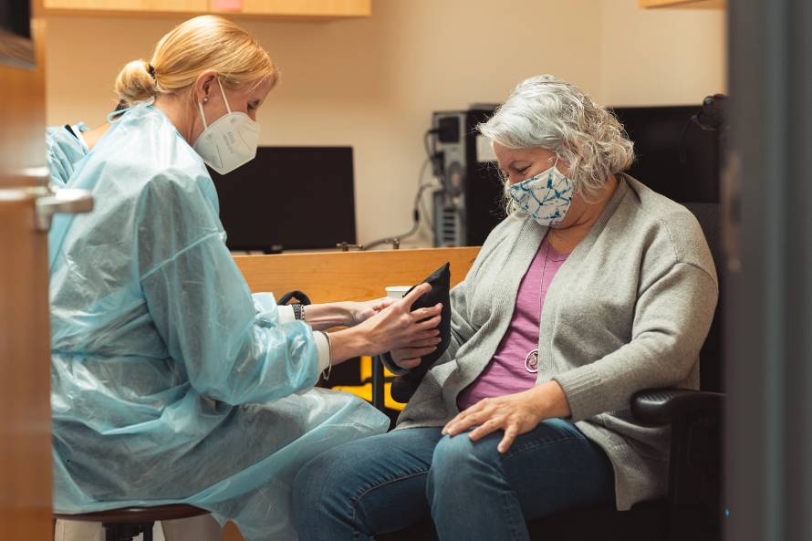 Postdoctoral researcher Caitlyn Seim takes measurements with a participant in the clinical trial. (Image credit: Andrew Brodhead)