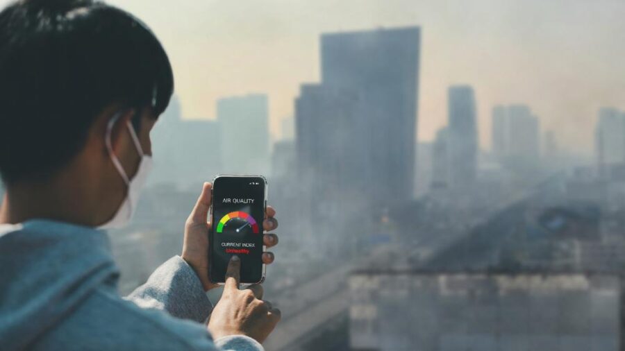 Woman using an air quality app on her cell phone