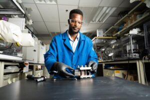 Lead author and battery researcher Gabriel Nambafu assembles a test flow battery apparatus.