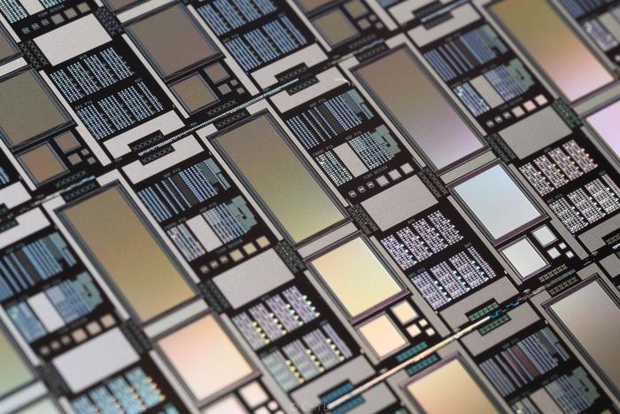 An exemplar photograph of an integrated chip containing memristor crossbar arrays of various sizes made at UMass Amherst. (Image taken by Can Li).