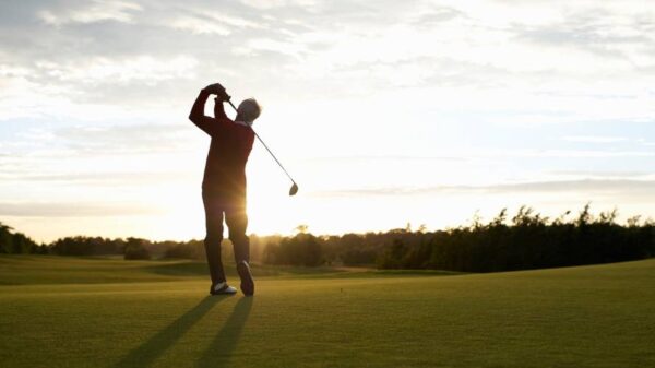 senior-man-golfing-sunset-swing