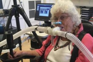 Mary Kaupas participates in a experiment to study how humans of various ages reach for targets. Tubes monitor her breathing to measure how much energy she uses. (Credit: Erik Summerside/Mary Kaupas)