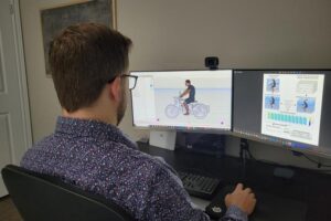 Justin Davidson, Biomechanics PhD candidate in the University of Waterloo's Department of Kinesiology and Health Sciences, using a digital human model to analyze the posture of a motorcycle rider.