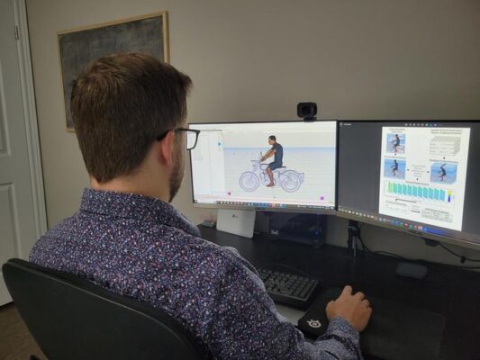 Justin Davidson, Biomechanics PhD candidate in the University of Waterloo's Department of Kinesiology and Health Sciences, using a digital human model to analyze the posture of a motorcycle rider.