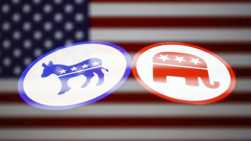 Democrat and Republic mascots superimposed on a U.S. flag