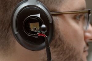 A University of Washington team has developed an artificial intelligence system that lets a user wearing headphones look at a person speaking for three to five seconds and then hear just the enrolled speaker’s voice in real time even as the listener moves around in noisy places and no longer faces the speaker. Pictured is a prototype of the headphone system: binaural microphones attached to off-the-shelf noise canceling headphones.