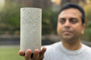 Dr Chamila Gunasekara holds a sample of the low-carbon concrete.