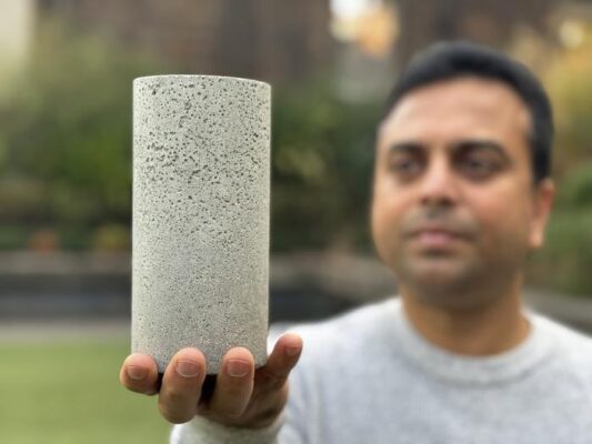 Dr Chamila Gunasekara holds a sample of the low-carbon concrete.