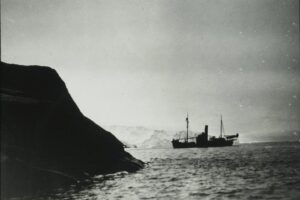 The whaling ship Firern, with the Stinson Reliant aircraft on board, near Klarius Mikkelsen Fjell in Lars Christensen Land in East Antarctica. Copyright Norwegian Polar Institute