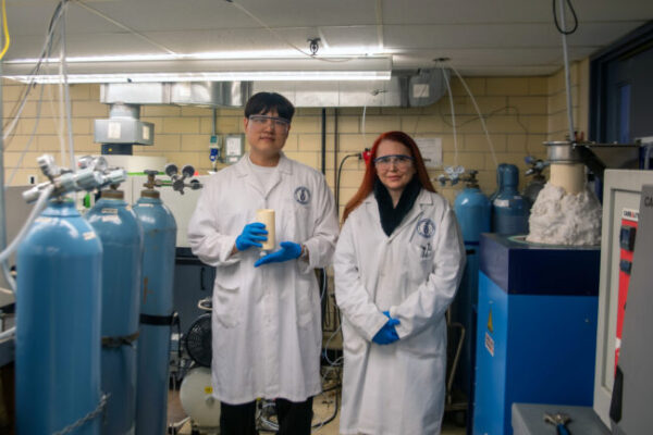 University of Toronto PhD candidate Jaesuk (Jay) Paeng stands next to Professor Gisele Azimi and holds the team’s newly designed electrochemical cell that can withstand temperatures up to 1600 degrees Celsius while electrochemically removing contaminants from steel using slag-based electrolyte.