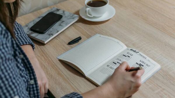 Woman filling out a healthy habits journal