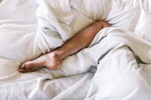 Woman covered with white blanket