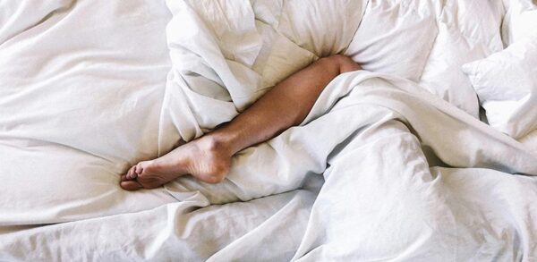 Woman covered with white blanket