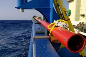 Caption - Coring barrel stowed along the starboard rail of the R/V Armstrong.