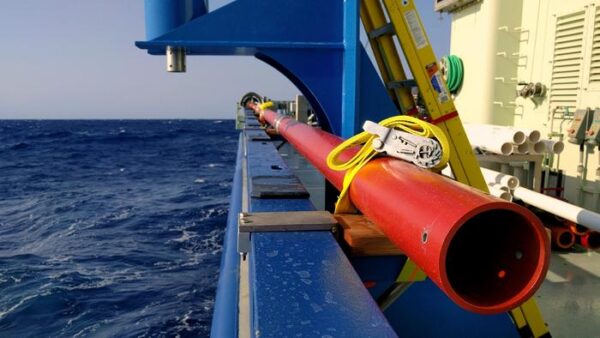 Caption - Coring barrel stowed along the starboard rail of the R/V Armstrong.