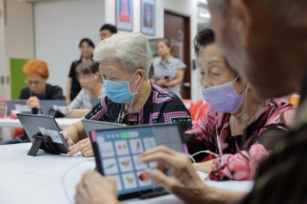 elderly playing language games on tablet computers