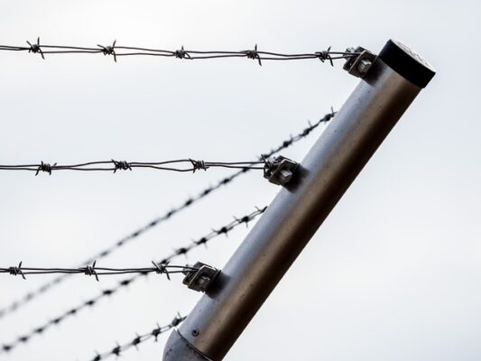 Corner of a barbed wire fence