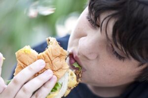 child eating a sandwich