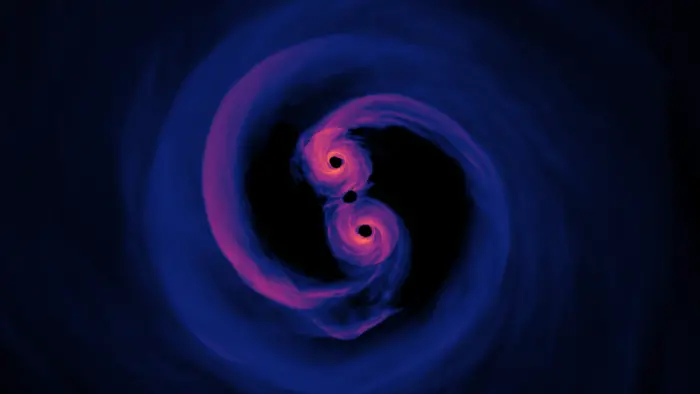 Simulation of the light emitted by a supermassive black hole binary system where the surrounding gas is optically thin (transparent). Viewed from 0 degrees inclination, or directly above the plane of the disk. The emitted light represents all wavelengths.