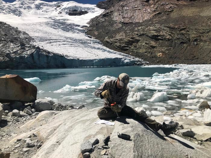 A researcher collects a sample of bedrock from the Queshque Glacier in the Peruvian Andes Mountains. The samples show tropical glaciers have retreated to their smallest size in more than 11,700 years based on cosmogenic nuclide measurements of recently exposed bedrock, an international team of scientists, led by Boston college researchers, reports in the journal Science.