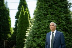 Aruni Bhatnagar, director of the University of Louisville Christina Lee Brown Envirome Institute, standing amid some of the 8,000 trees and shrubs planted for the project.