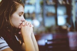 red headed woman looking like she's praying