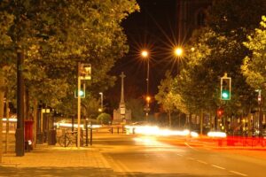 A neighborhood with trees at night