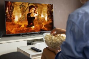 man watching action film at home