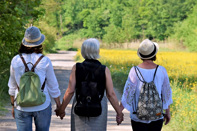 three women with their backs to us walking down a trail