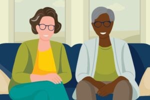 Vector art of two women sitting in a couch smiling