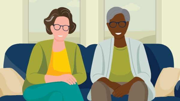 Vector art of two women sitting in a couch smiling