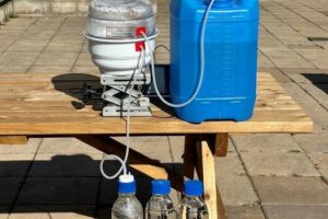 Mock-up of solar evaporation system (left), connected to temperature and humidity detection system (center), with a brine water injection system (right) and a purified water collection system.