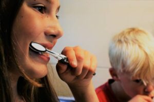 mother and son brushing their teeth