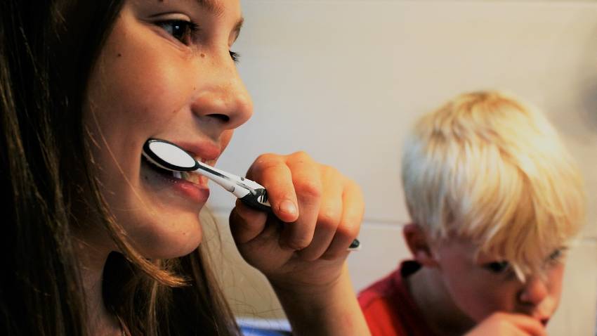 mother and son brushing their teeth